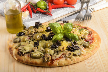 freshly baked pizza with olive and melted cheese on a wooden boa