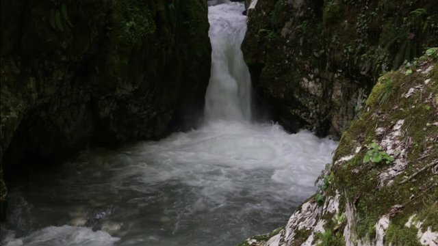 Waterfall in the rocks, the river flowing through a narrow crack, Abkhazia and the Caucasus. Bzyb River National Park Ritz.