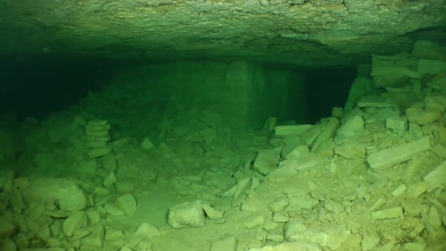 The camera zooms in branching of corridors of a flooded mine.


