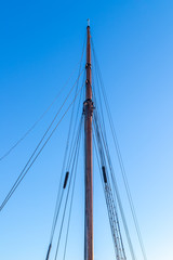 mast sailing yacht in the background of blue sky