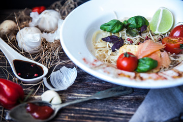 Italian food. Pasta penne with brussels sprouts, champignons, basil, sauce, tomatoes