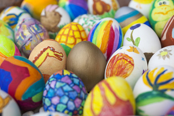 Fototapeta na wymiar Detail of painted Easter eggs with different forms, cartoons and bright colors. 