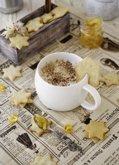 cup of aromatic cappuccino with cookies, orange marmalade. selective focus