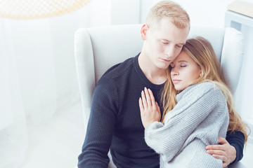 Woman sleeping on man's chest