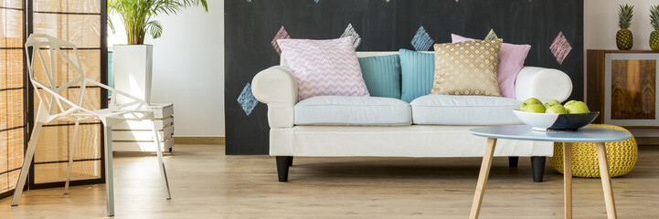 Room with sofa full of cushions