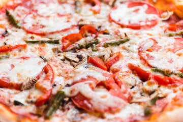 Pizza with tomato, mushrooms, bell peppers closeup