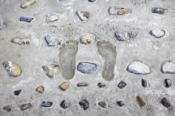 Fototapeta na wymiar Footprints on the wet cement 