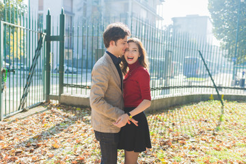 Young beautiful couple in love having fun outdoor in back light, hugging - happiness, romance,...