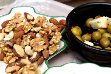 Olives, feta cheese, crisps, walnuts, almonds, cashew nuts, brazil nuts and hazelnuts served with an aperitif