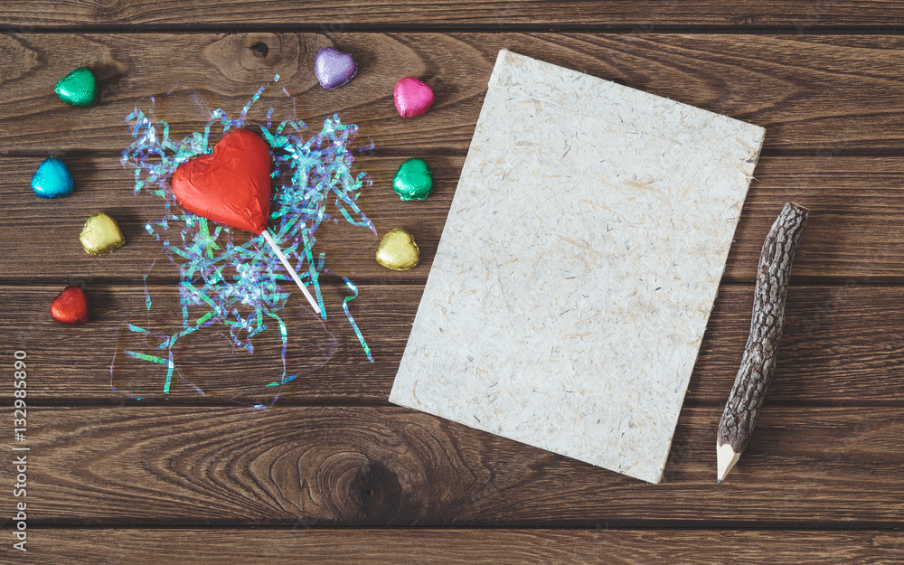 Poster top view image of colorful heart shape chocolates with blank pap