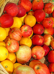 background of ripe apples and oranges