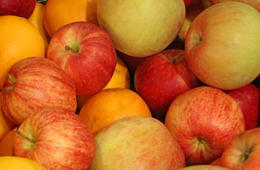 background of ripe apples and oranges orange