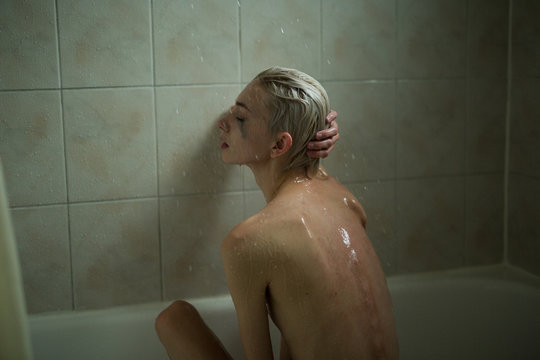 Water falls and woman cries from sadness and fear