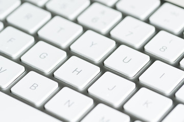computer keyboard with keys in the foreground on table