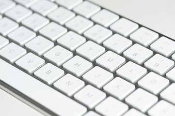 computer keyboard with keys in the foreground on table