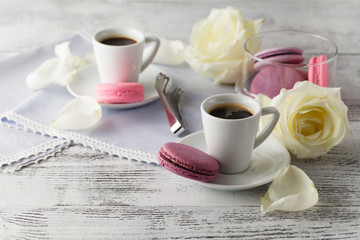 Coffee and white roses on table