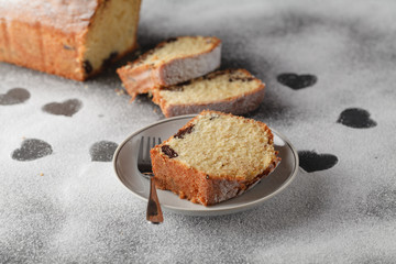 sliced cake and heart of flour on wooden desk