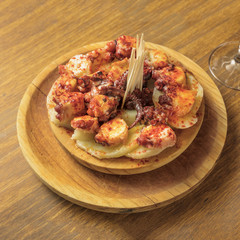 Photo of octopus with fried potatoes, typical Spanish dish