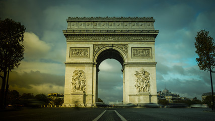 Fototapeta na wymiar Triumphal Arch in Paris with traffic cars from Champs Elysees