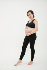 Pregnant Woman Standing and Patting Her Belly