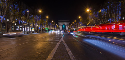 Champs Elysees in Paris illuminated for Christmas and Triumphal Arch in background