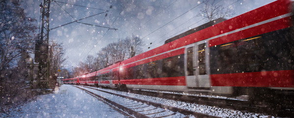 red train speeding in the snow - Powered by Adobe