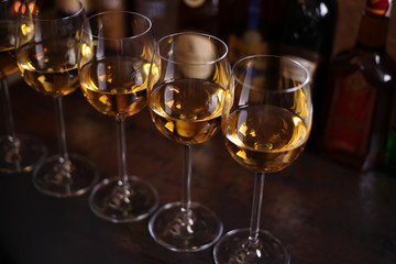 Row of glasses of white wine in the bar. Alcohol drink in glasses