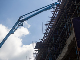 Fototapeta na wymiar Building under construction. The site with cranes against blue sky