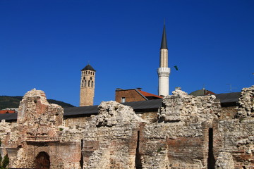 Fototapeta na wymiar Clock tower and mosque minaret in old part of Sarajevo , Bosnia and Herzegovina 