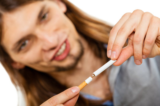 Young man is breaking a cigarette