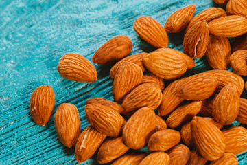 handful of almonds on a blue wooden background