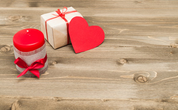decor for Valentine's Day. Gifts and candles for the holiday on the wooden background.