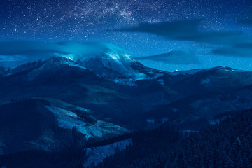 Night sky above snow-capped peaks