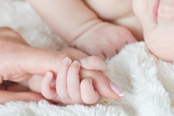 Hand the sleeping baby in the hand of mother close-up .Soft focu