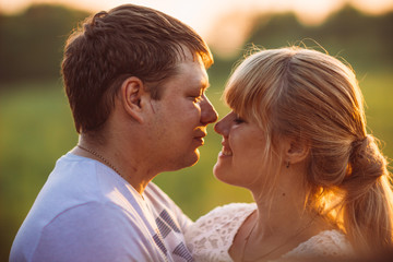 portrait of love story man and woman on the background haystacks