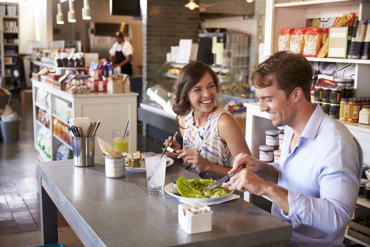 Couple Enjoying Lunch Date In Delicatessen Restaurant