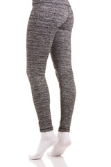 Sexy back view of fit woman legs in white socks standing on toes with one leg bended in grey patterned thermal pants