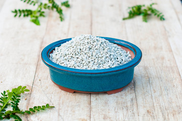 Drainage for indoor plants in pots on a wooden table.