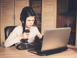 Kid playing online pc game. Emotional kid play and win video games