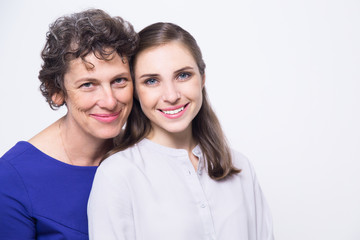 Portrait of happy senior woman and young daughter