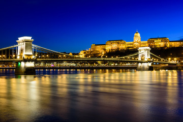 Hungarian landmarks, Chain Bridge, Royal Palace and Danube river in Budapest at night.