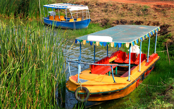 Colorful old style boats in small lake in India.