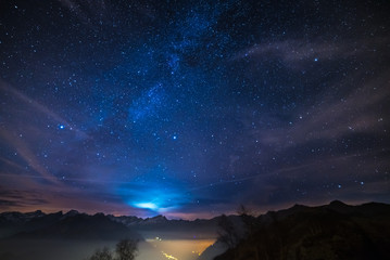 Night on the Alps under starry sky and moonlight