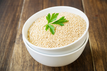 Raw quinoa in white bowl