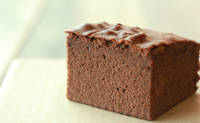 Chocolate cake on paper with copy space.