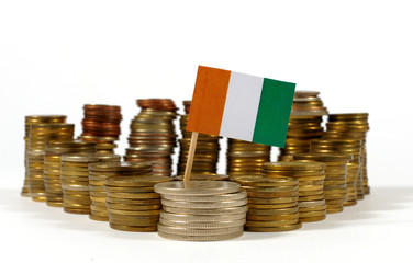 Ivory Coast flag waving with stack of money coins