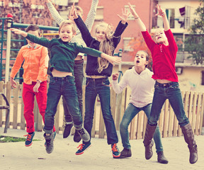 Happy kids having fun and jumping up