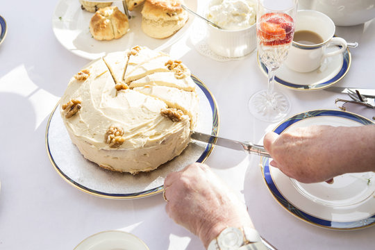 Person slicing a piece of cake