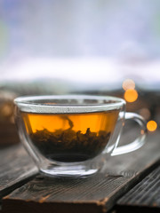 Transparent Cup of tea on wooden background