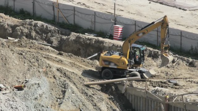 Excavator leveled the road to the construction site